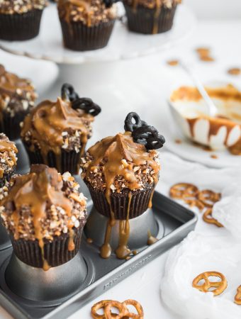 Chocolate caramel cupcakes with chocolate pretzel butterfly and drizzled caramel