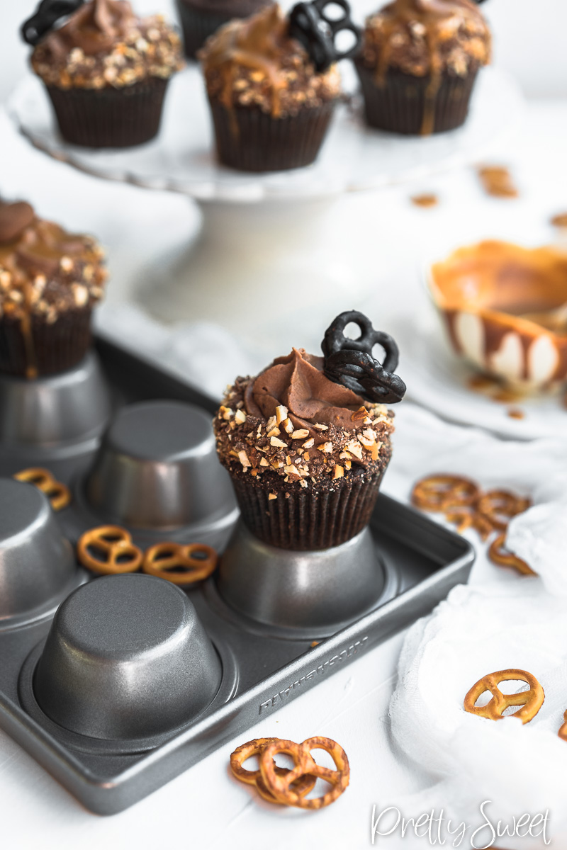 Salted Caramel filled Chocolate Cupcakes with whipped milk chocolate ganache and chocolate butterfly pretzels 