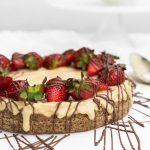 Chocolate cheesecake with strawberries on top and drizzled chocolate