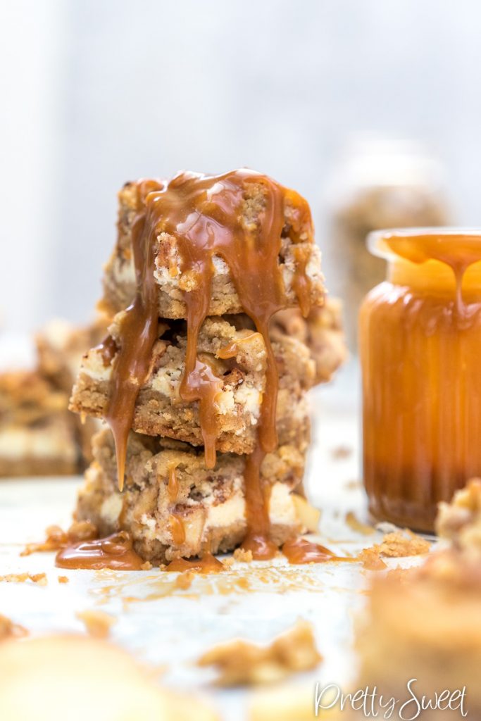 Apple Crumble Cheesecake Bars with Salted Caramel Sauce in a tower stack