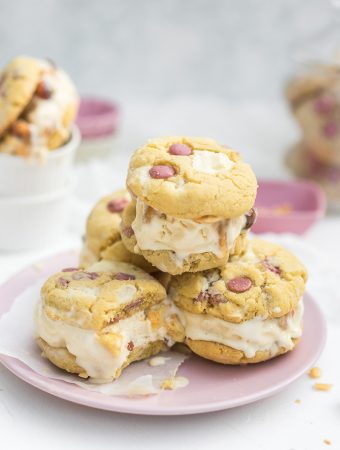 Bitten ice cream cookie sandwiches with ruby and white chocolate stacked on top of each other