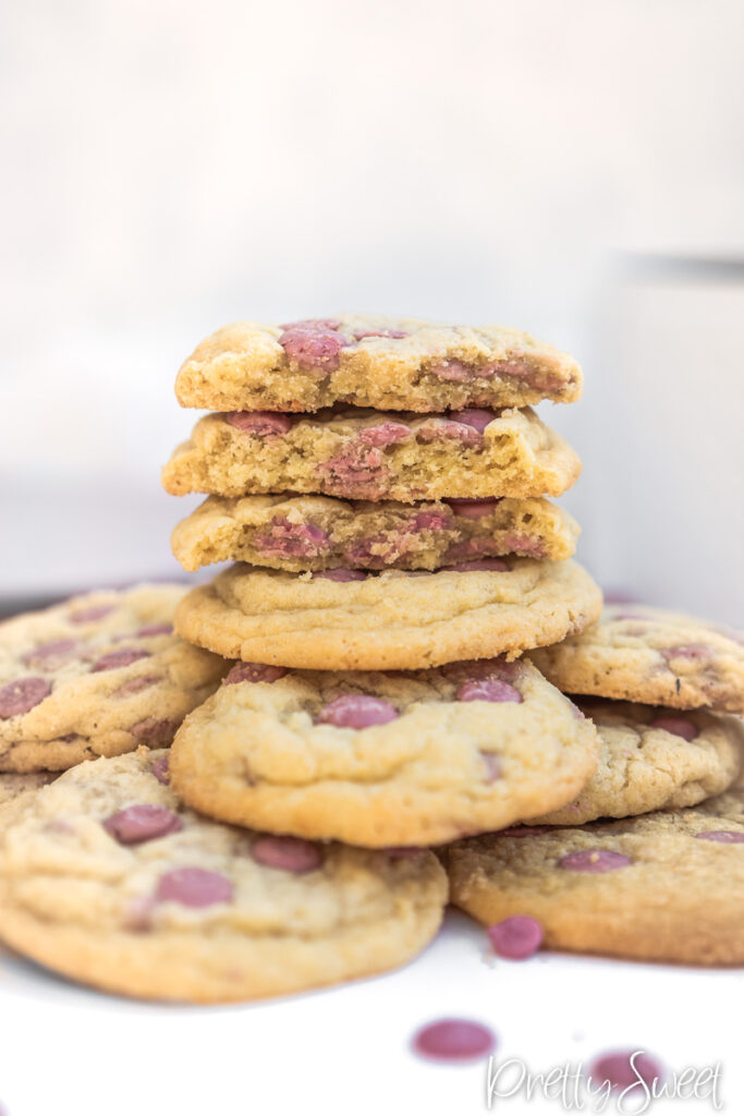 Stacked halved ruby cookies on a pile of cookies