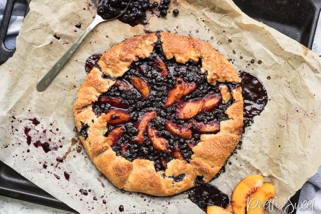 Peach Blueberry Galette baked on a black baking pan