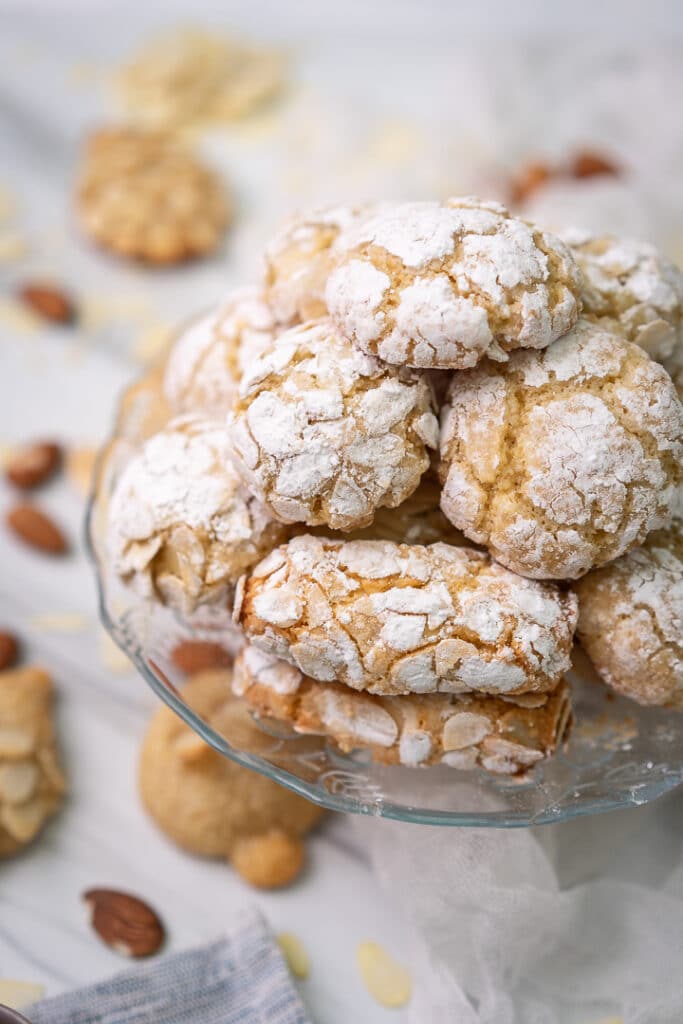 round and oval amaretti cookies on a glass cake stand
