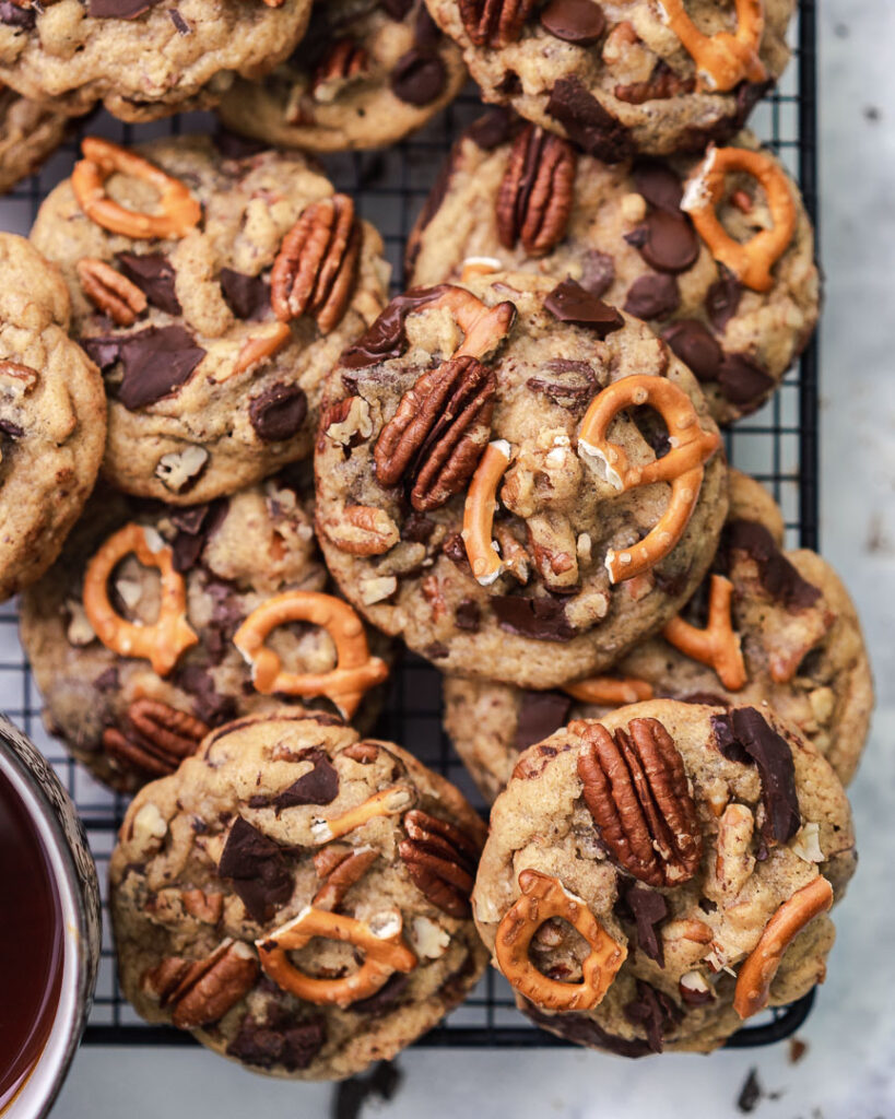 pretzel chocolate chip pecan cookies stacked on a rack flat lay