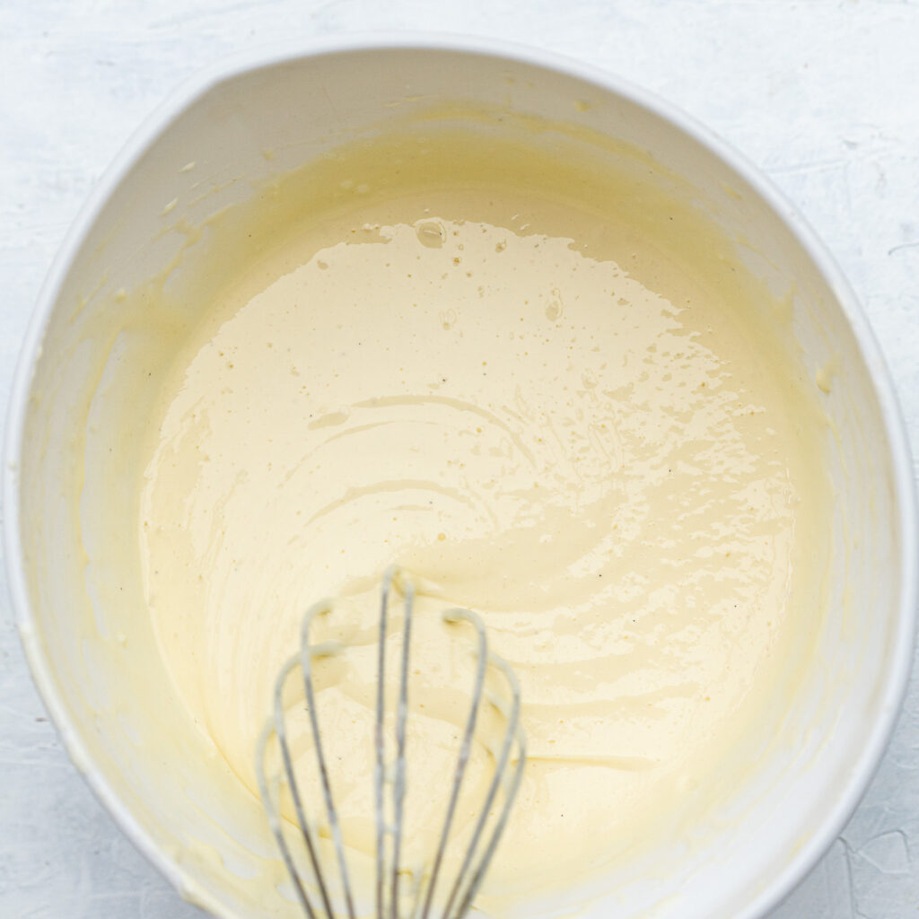 mixed cheesecake batter filling in a white bowl