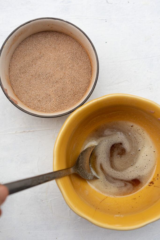 cinnamon c+sugar in a bowl and browned butter in a yellow bowl