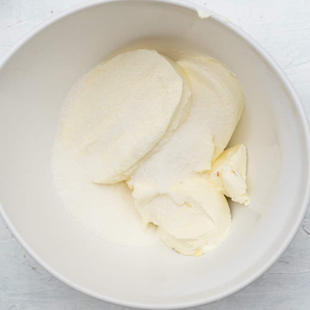 cream cheese and sugar in a white bowl