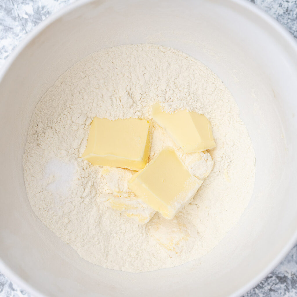 flour and butter in a white bowl